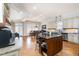 Open-concept kitchen with an island featuring bar stool seating and stainless steel appliances at 12345 Beestone Ln, Raleigh, NC 27614
