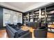 Library room featuring built-in bookshelves, hardwood floors, and natural light from the windows at 12345 Beestone Ln, Raleigh, NC 27614