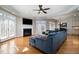 Inviting living room with a fireplace, hardwood floors, and large windows allowing plenty of natural light at 12345 Beestone Ln, Raleigh, NC 27614