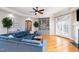 Bright living room with hardwood floors, a blue sectional sofa, and built-in shelving at 12345 Beestone Ln, Raleigh, NC 27614