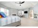 Spacious main bedroom featuring a tray ceiling, fireplace, chaise lounge, and neutral tones at 12345 Beestone Ln, Raleigh, NC 27614