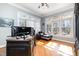Bright office features a desk, sitting area, and large windows that provide natural light and views of the outdoors at 12345 Beestone Ln, Raleigh, NC 27614