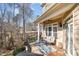 Serene porch with comfortable seating, ceiling fan and outdoor curtains, offering a private view of the forest at 12345 Beestone Ln, Raleigh, NC 27614