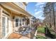 Relaxing porch featuring an outdoor dining area with a partial view of the yard and neighboring houses at 12345 Beestone Ln, Raleigh, NC 27614