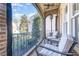 Covered porch area with brick floor, ceiling fan, and a pair of chairs and a table overlooking the landscaped yard at 12345 Beestone Ln, Raleigh, NC 27614