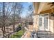 A cozy porch featuring a dining table and an outside view of a wooded area, as well as grill at 12345 Beestone Ln, Raleigh, NC 27614