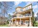 Expansive rear exterior featuring a brick patio, upper and lower decks, and a well-maintained yard at 12345 Beestone Ln, Raleigh, NC 27614