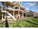 Rear exterior of home with balconies, brick pillars, steps to the backyard, and a well-maintained lawn at 12345 Beestone Ln, Raleigh, NC 27614