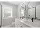 Bathroom features double vanity with modern fixtures and a tiled shower at 1410 Joe Louis Ave, Raleigh, NC 27610