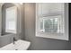Bathroom features a sink, mirror, and window with natural light at 1410 Joe Louis Ave, Raleigh, NC 27610