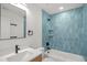 Modern bathroom with blue tile, sleek fixtures, bathtub, and a contemporary vanity at 1410 Joe Louis Ave, Raleigh, NC 27610