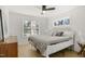 Bright bedroom features large windows, hardwood floors, and ceiling fan at 1410 Joe Louis Ave, Raleigh, NC 27610