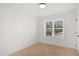 Bright bedroom featuring a window that provides natural light and hardwood floors at 1410 Joe Louis Ave, Raleigh, NC 27610