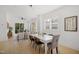 Inviting dining room featuring modern table setting, hardwood floors, and natural light, connecting to the living room at 1410 Joe Louis Ave, Raleigh, NC 27610