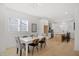 Bright dining room with hardwood floors open to the kitchen, featuring a white table with seating for six at 1410 Joe Louis Ave, Raleigh, NC 27610