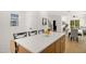 Kitchen island with seating and quartz countertop adjacent to dining and living area at 1410 Joe Louis Ave, Raleigh, NC 27610