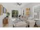 Bright living room with modern ceiling fan, stylish furniture, and sliding glass doors to a deck at 1410 Joe Louis Ave, Raleigh, NC 27610