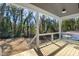 Covered porch with seating and lighting fixtures, overlooking a spacious yard at 1410 Joe Louis Ave, Raleigh, NC 27610