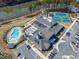 Aerial view of the community clubhouse, featuring a pool, tennis courts, and gathering spaces at 1413 Buxus Ct, Fuquay Varina, NC 27526