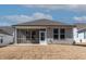 Rear of the house featuring a screened-in porch and a concrete patio, ideal for relaxing and enjoying outdoor living at 1413 Buxus Ct, Fuquay Varina, NC 27526