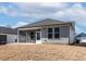 Back exterior featuring a screened in porch and concrete patio with ample space for seating and entertaining at 1413 Buxus Ct, Fuquay Varina, NC 27526
