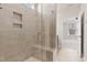 Elegant bathroom shower with built in bench and doorway to bedroom and walk in closet at 1413 Buxus Ct, Fuquay Varina, NC 27526