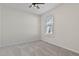 Neutral bedroom featuring a ceiling fan, window, and plush carpet providing a comfortable living space at 1413 Buxus Ct, Fuquay Varina, NC 27526