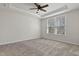 Bedroom featuring large windows with a tray ceiling, a ceiling fan, carpeted floors, and lots of natural light at 1413 Buxus Ct, Fuquay Varina, NC 27526