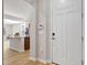 Bright entryway with a white door leading to an open-concept kitchen and living area at 1413 Buxus Ct, Fuquay Varina, NC 27526