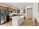 Spacious kitchen features stainless steel appliances, a large island with a white countertop, and wooden cabinets at 1413 Buxus Ct, Fuquay Varina, NC 27526