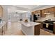 Modern kitchen with a center island, stainless steel appliances, and an open view to the living room at 1413 Buxus Ct, Fuquay Varina, NC 27526