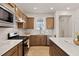 Close-up of a kitchen showcasing stainless steel appliances, a white countertop, and wooden cabinets at 1413 Buxus Ct, Fuquay Varina, NC 27526