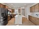 Bright kitchen with stainless steel appliances, a center island with white countertops, and wood-look flooring at 1413 Buxus Ct, Fuquay Varina, NC 27526