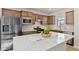 Well-lit kitchen features stainless steel appliances, an island with a white countertop, and plenty of cabinet space at 1413 Buxus Ct, Fuquay Varina, NC 27526