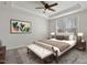 Elegant main bedroom with tray ceiling, ceiling fan, natural light, bed, bench, and neutral décor at 1413 Buxus Ct, Fuquay Varina, NC 27526