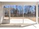 Covered screened-in patio offers a serene view of the wooded backyard, perfect for enjoying nature at 1413 Buxus Ct, Fuquay Varina, NC 27526