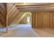 Spacious unfinished attic space, featuring wood framing and a window at 15 Harvest View Way, Franklinton, NC 27525