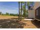 Exterior view of backyard, porch and adjacent grass field, and tall trees at 15 Harvest View Way, Franklinton, NC 27525