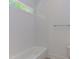 This bathroom features a bathtub with white tile surround, a chrome towel rack, and light-colored flooring at 15 Harvest View Way, Franklinton, NC 27525