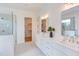 Luxurious bathroom featuring a double vanity, a walk-in shower with glass doors, and ceramic tile flooring at 15 Harvest View Way, Franklinton, NC 27525