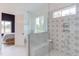 Beautiful ensuite bathroom featuring a walk-in shower, designer tile, and clear glass doors to the main bedroom at 15 Harvest View Way, Franklinton, NC 27525