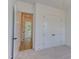 This bedroom features neutral carpeting, bright white walls, a closet, and trim for a clean, modern look at 15 Harvest View Way, Franklinton, NC 27525