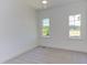 Well-lit bedroom with plush carpeting and large windows with backyard views at 15 Harvest View Way, Franklinton, NC 27525