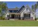 Charming two-story home featuring a manicured lawn and welcoming front porch at 15 Harvest View Way, Franklinton, NC 27525