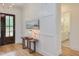 Bright entryway featuring detailed trim work, a hall table, and view to a half-bathroom at 15 Harvest View Way, Franklinton, NC 27525
