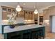 A kitchen with white quartz countertops, a center island, and stainless steel appliances at 15 Harvest View Way, Franklinton, NC 27525