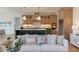 A bright kitchen with a breakfast bar, modern lighting, and open layout to the living area at 15 Harvest View Way, Franklinton, NC 27525