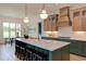 A bright kitchen with a center island, pendant lights, and stainless steel appliances at 15 Harvest View Way, Franklinton, NC 27525