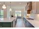 A view of the dining area and bright kitchen from behind the sink at 15 Harvest View Way, Franklinton, NC 27525