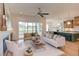 Bright living room with a fireplace, large windows, and an adjacent eat-in kitchen at 15 Harvest View Way, Franklinton, NC 27525